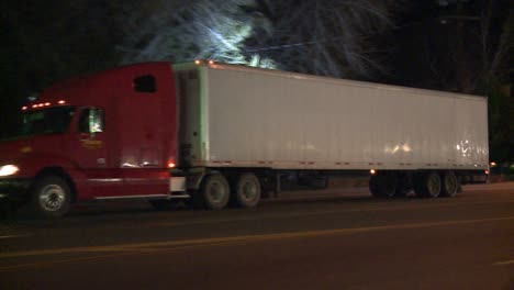 An-unmarked-double-tractor-trailer-truck-drives-through-the-night-1