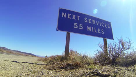 A-sign-on-a-lonely-desert-road-warns-that-the-next-services-are-55-miles-away-1