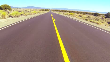 POV-shot-driving-along-a-desert-road-at-a-fast-speed