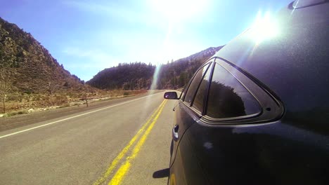 POV-shot-conduciendo-fast-along-a-montaña-road-with-the-car-visible