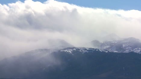 Clouds-blow-over-the-top-of-an-alpine-mountain-range-in-winter
