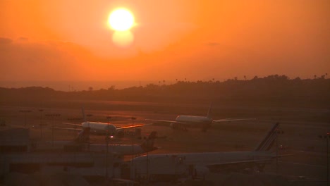 Planes-taxi-at-sunset-or-sunrise-at-a-major-metropolitan-airport