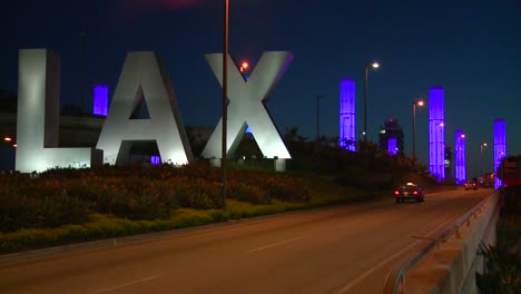 Cars-pass-by-the-LAX-sign-on-their-way-into-Los-Angeles-airport-1