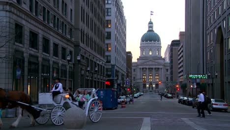 A-horse-drawn-carriage-passes-the-downtown-capital-building-in-Indianapolis-Indiana-1