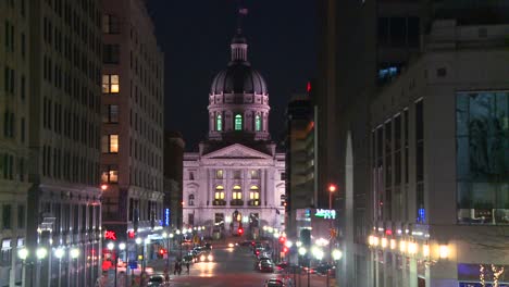 A-horse-drawn-carriage-passes-the-Indiana-state-capital-building-in-Indianapolis-at-night-1
