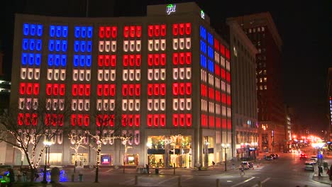 An-office-building-is-lit-up-at-night-with-the-American-flag