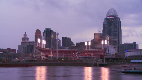 Nighttime-falls-over-Cincinnati-as-riverboats-pass-on-the-Ohio-River
