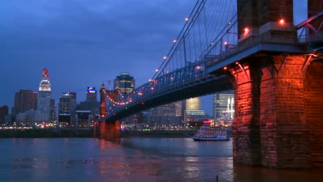 A-riverboat-travels-at-night-with-the-Cincinnati-Ohio-skyline-background
