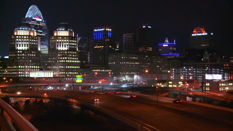 An-establishing-shot-of-Cincinnati-Ohio-at-night-with-freeways-foreground