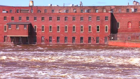 A-flooding-river-flows-past-an-old-factory