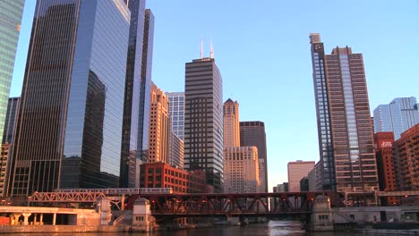 The-El-train-travels-over-a-bridge-in-front-of-the-Chicago-skyline