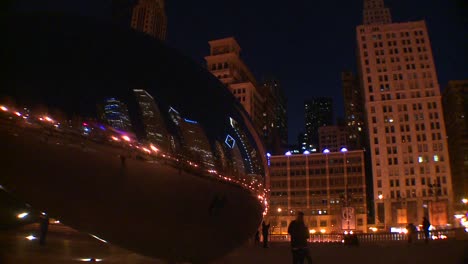 Downtown-Chicago-skyline-at-night-reflected-partly-in-the-Bean-at-Millennium-park-2