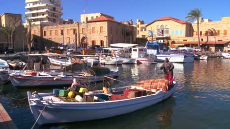 A-traditional-fisherman-works-on-his-net-in-a-harbor-in-Tyre-Lebanon-2