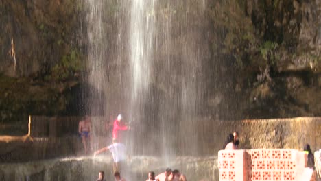 People-bathe-under-a-large-waterfall-of-hot-water-at-a-Dead-Sea-resort-in-Jordan--1