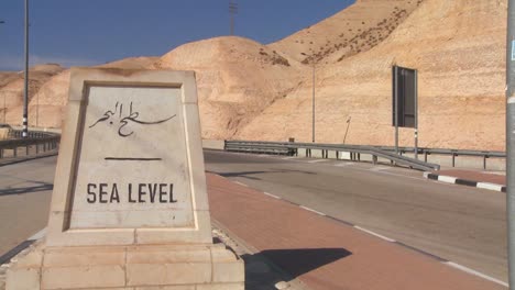 A-road-passes-a-sign-indicating-Sea-Level-near-the-Dead-Sea-in-Israel
