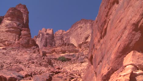 People-climb-up-a-steep-canyon-into-the-dry-mountains-of-Wadi-Rum-Jordan