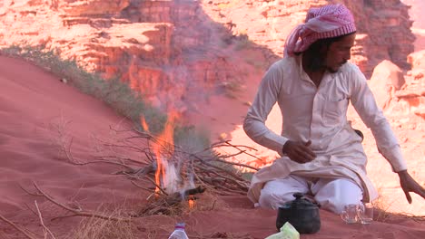 A-Bedouin-man-makes-a-fire-by-hand-in-the-desert