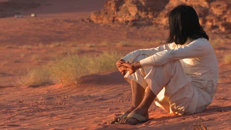 Ein-Beduinenmann-Sitzt-Und-Betrachtet-Die-Wüste