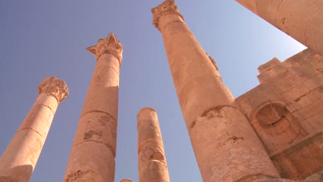 A-low-angle-shot-looking-up-at-pillars-in-the-Roman-city-of-Jerash-in-Jordan