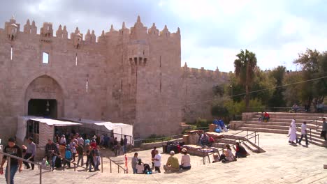 Pan-across-of-people-walk-out-of-the-Damascus-Gate-in-the-old-city-of-Jerusalem-
