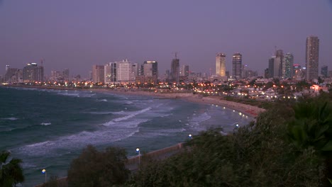 Modern-buildings-of-Tel-Aviv-Israel-at-night-with-beach-and-ocean-nearby