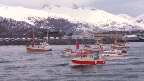 A-large-fleet-of-commercial-fishing-boats-sails-out-to-sea-of-Norway-in-the-Lofoten-Islands-2