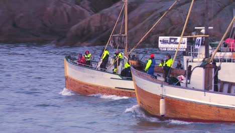 A-large-fleet-of-traditional-commercial-fishing-boats-sails-out-to-sea-of-Norway-in-the-Lofoten-Islands