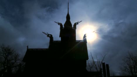 The-sun-shines-behind-a-spooky-stave-church-in-Norway-in-time-lapse