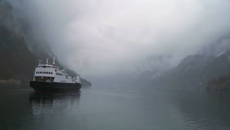 A-ferry-boat-sails-through-mysterious-fog-on-a-fjord-in-Norway