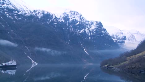 A-ferry-boat-sails-into-the-fog-of-a-Norway-fjord
