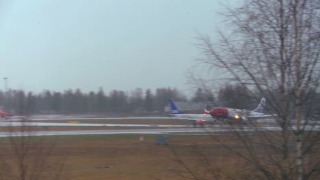 A-plane-comes-in-for-a-landing-at-an-airport-on-a-rainy-day-1