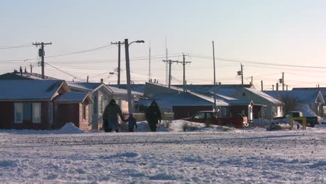 People-walk-along-a-snowy-road-at-Churchill-Manitoba-Canada-Hudson-Bay