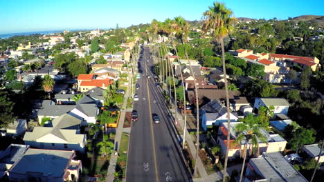 Rising-aerial-shot-over-a-palm-tree-lined-street-in-Southern-California