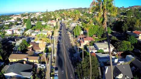 Beautiful-aerial-shot-over-a-palm-tree-lined-street-in-Southern-California