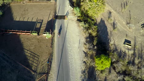 A-beautiful-aerial-shot-over-a-man-riding-his-Harley-motorcycle-on-the-open-road-3