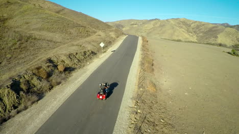 A-beautiful-vista-aérea-shot-over-a-man-riding-his-Harley-motorcycle-on-the-open-road-4