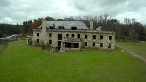 An-aerial-over-a-spooky-abandoned-mansion-in-the-countryside