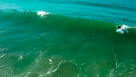 Aerial-over-surfers-riding-waves-on-a-Southern-California-beach
