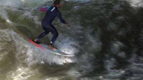 Surfers-brave-the-rapids-of-the-Eisbach-River-in-Munich-Germany-in-slow-motion-1