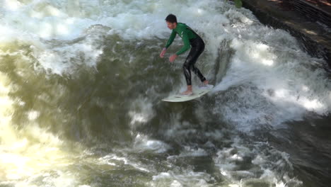 Surfers-brave-the-rapids-of-the-Eisbach-River-in-Munich-Germany-in-slow-motion-3