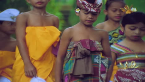 Children-walk-into-a-remple-in-Bali-Indonesia-during-a-religious-ritual