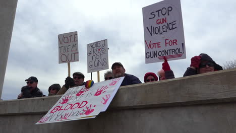 Protestors-hold-signs-against-gun-violence-in-schools-during-the-March-For-Our-Lives-Protest
