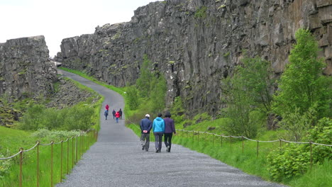 Los-Turistas-Caminan-Por-La-Cordillera-Del-Atlántico-Medio-En-Thingvellir-Islandia