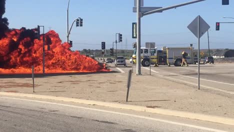 A-car-Kia-Soul-fire-burns-in-an-intersection-with-a-fire-truck-nearby-near-Ventura-California