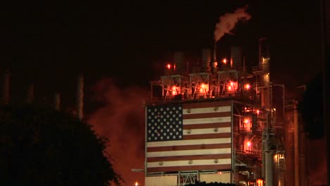 Rauch-Steigt-Aus-Einer-Ölraffinerie-Auf,-Nachts-Beleuchtet