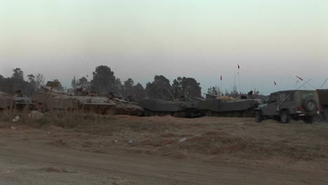 Armored-vehicles-wait-at-an-Israeli-army-staging-post-at-the-Gaza-strip-border