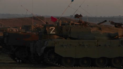 Israeli-armored-vehicles-wait-at-an-army-staging-post-on-the-Gaza-Strip-border