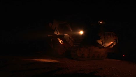 An-Israeli-armored-bulldozer-patrols-the-Israel--Gaza-Strip-border-at-night