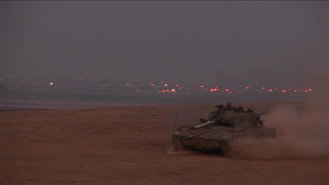 An-Israeli-tank-moves-across-a-no-man's-land-between-Israel-and-the-Gaza-Strip