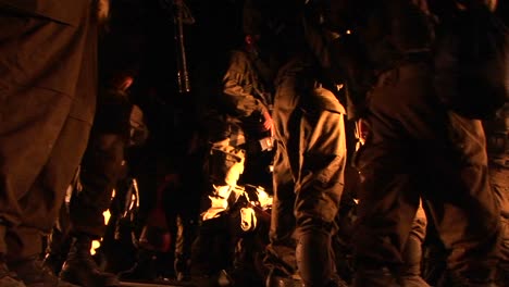 Israeli-soldiers-with-guns-mill-about-during-a-night-patrol